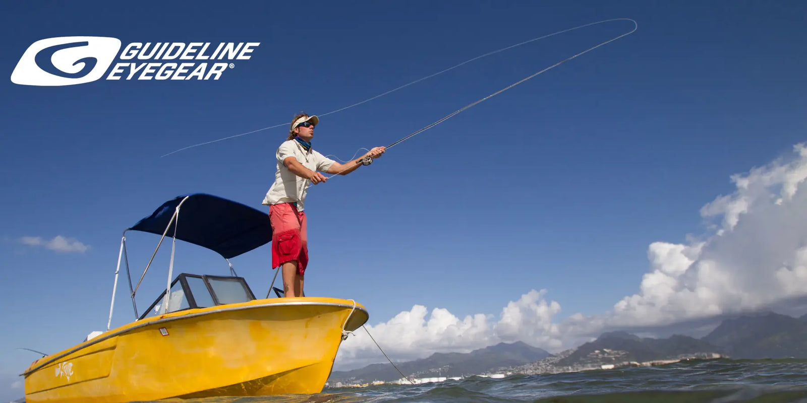Guideline Eyegear banner depicting a man on boat fishing out at sea.